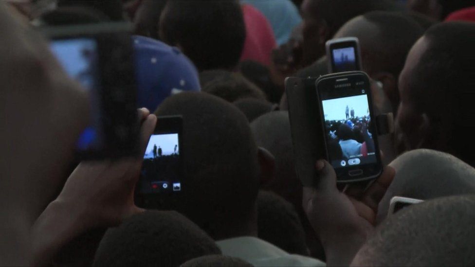 People using mobile phones in Uganda