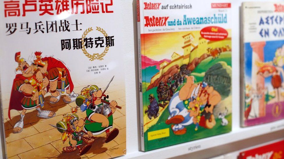 Asterix comics on a shelf in various languages