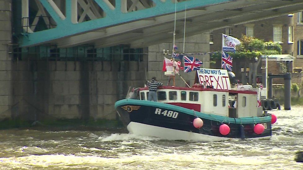 Fishing boat passing underneath Tower Bridge