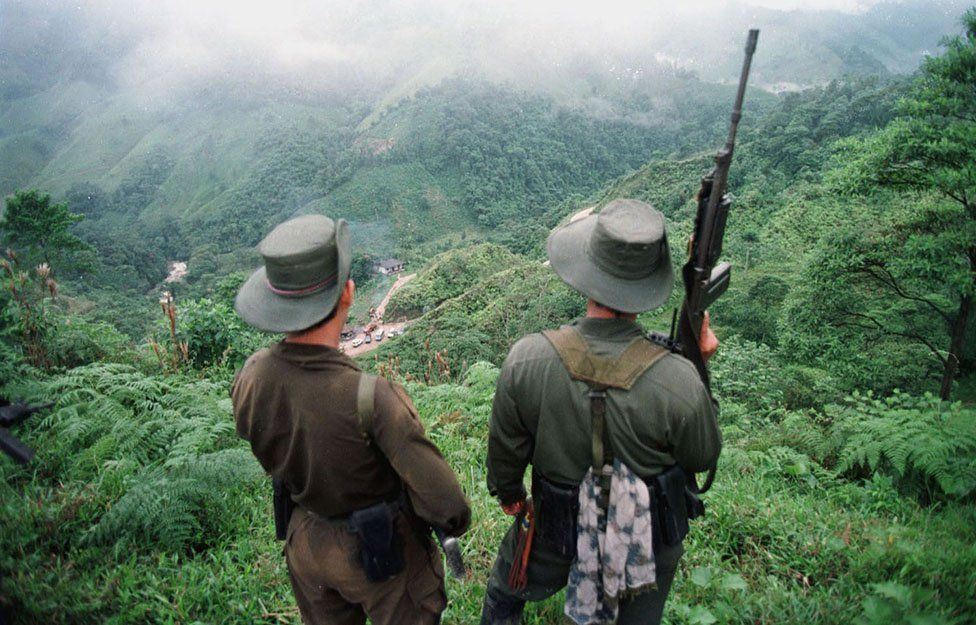Two armed soldiers belonging to the Revolutionary Armed Forces of Colombia (FARC) in an image from 1998