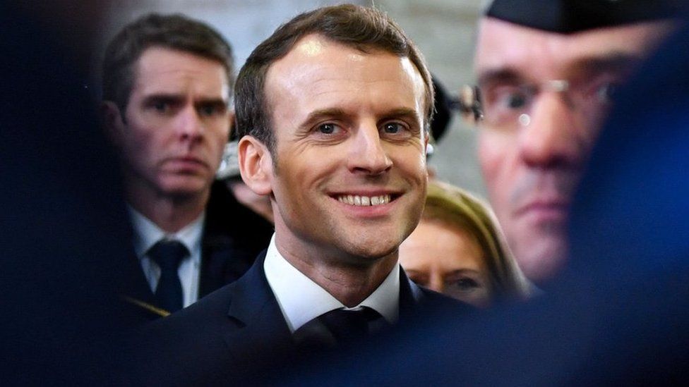 French President Emmanuel Macron smiles during his visit in the French northern city of Calais on 16 January