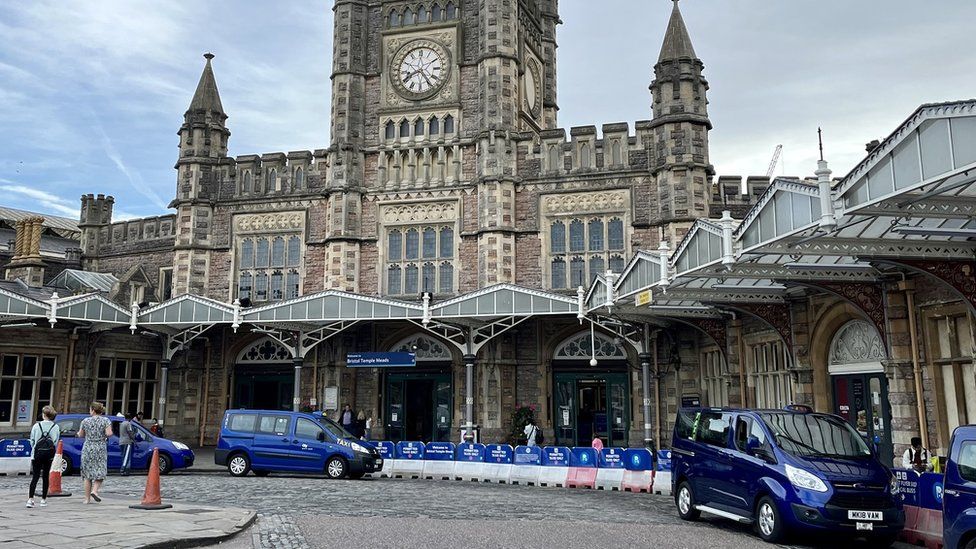 The front entrance to Bristol Temple Meads station showing blue taxis lined up
