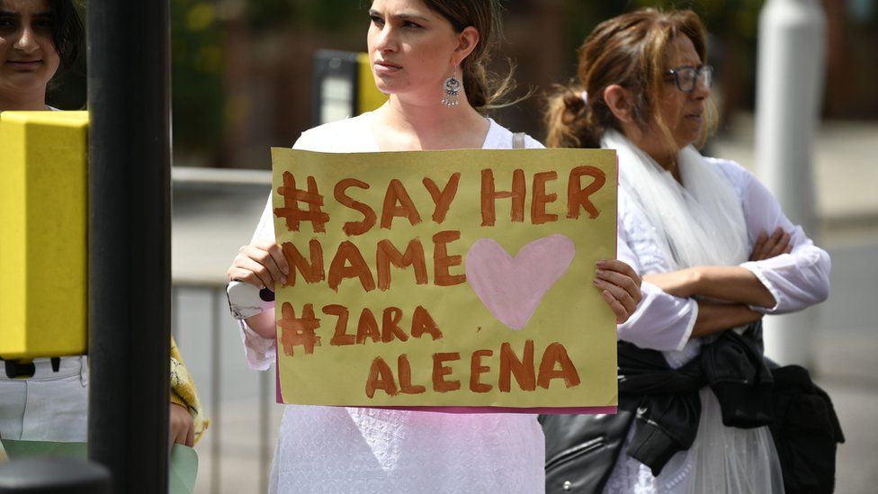 Woman holding sign