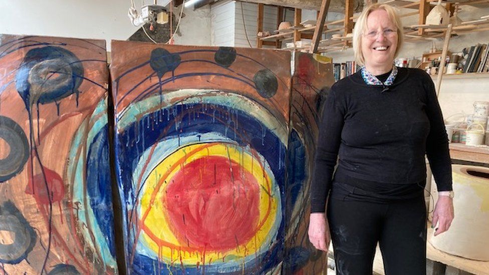 Artist Sandy Brown alongside Earth Goddess, which is currently in progress