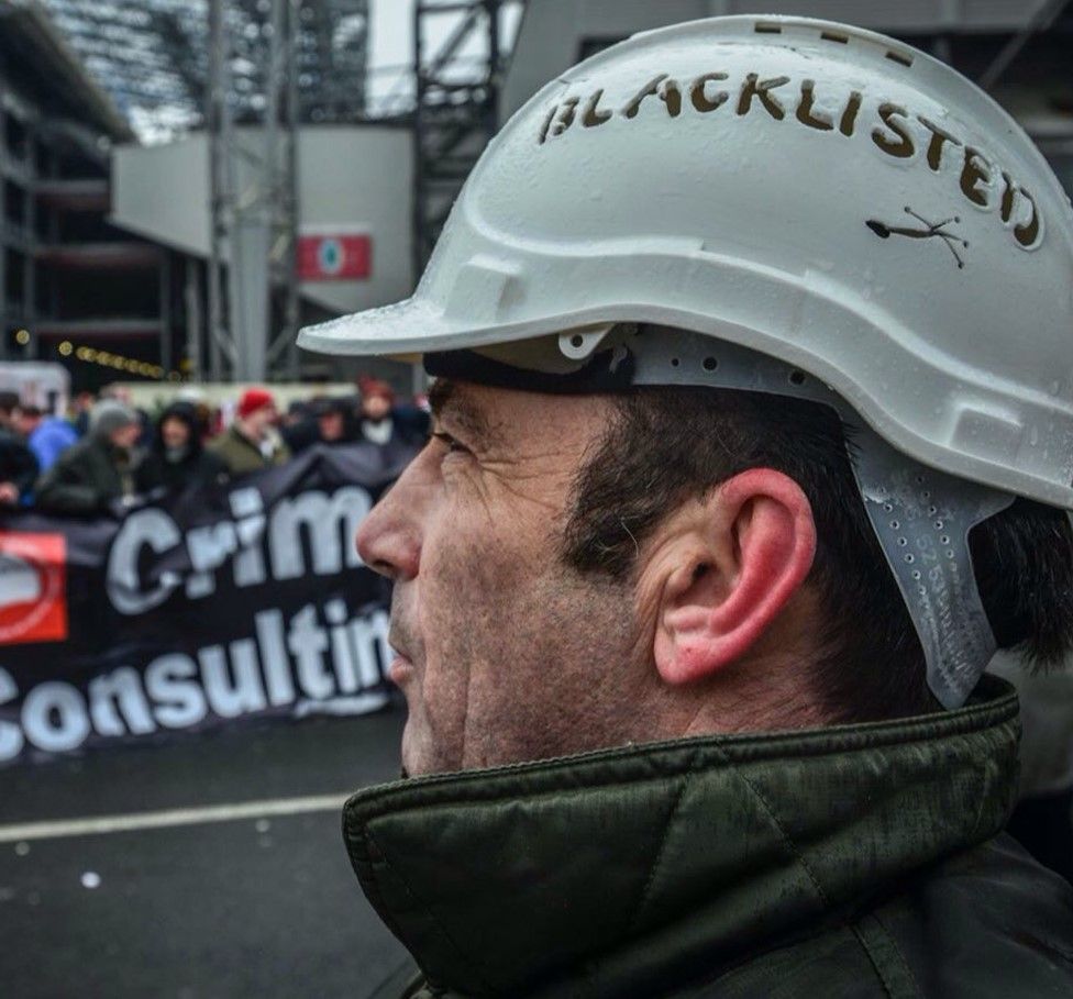 A Blacklist campaigner wearing a hardhat declaring he had been "blacklisted"