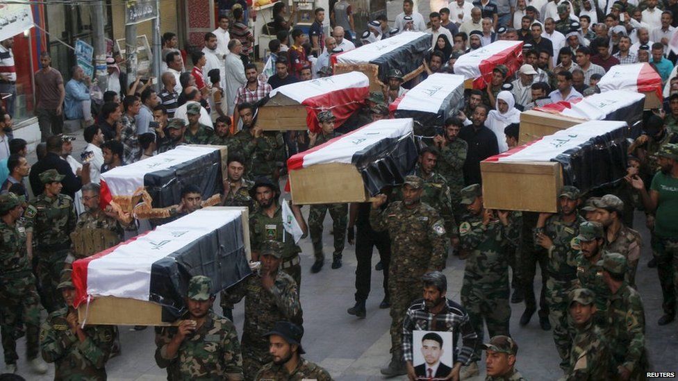 Iraqi Shia militiamen carry the coffins of soldiers killed in the Speicher massacre (1 July 2015