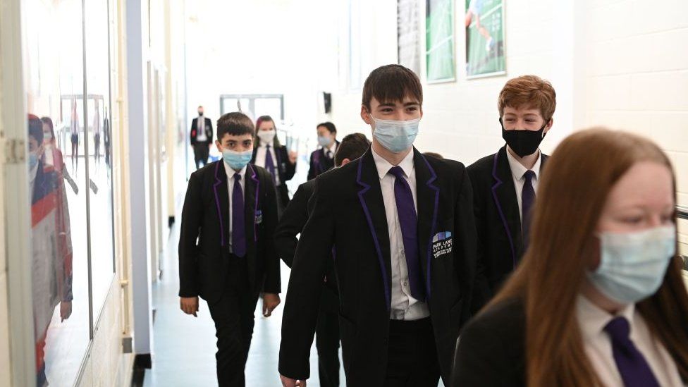 A Year 9 class walk along a corridoor at Park Lane Academy in Halifax, northwest England on March 4, 2021.