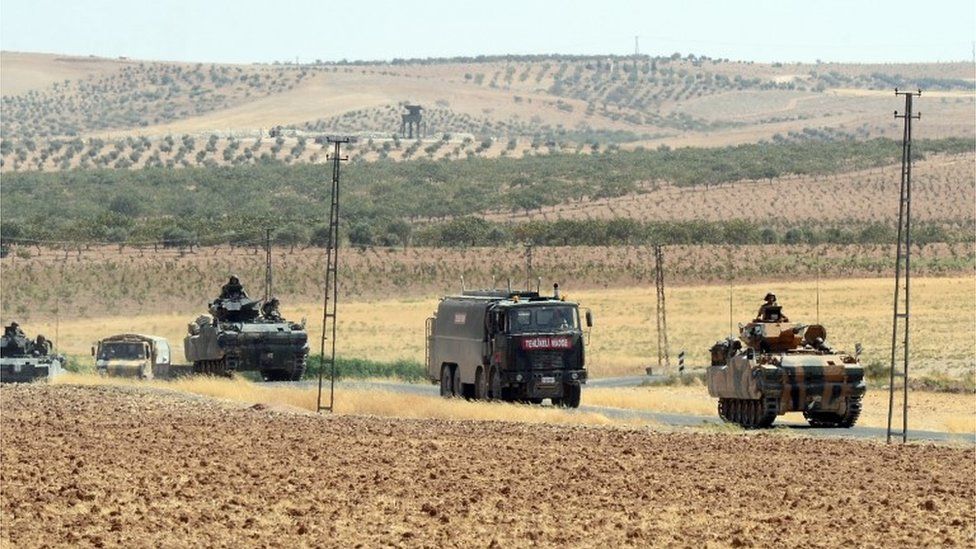 Turkish military vehicles return from the Syrian border