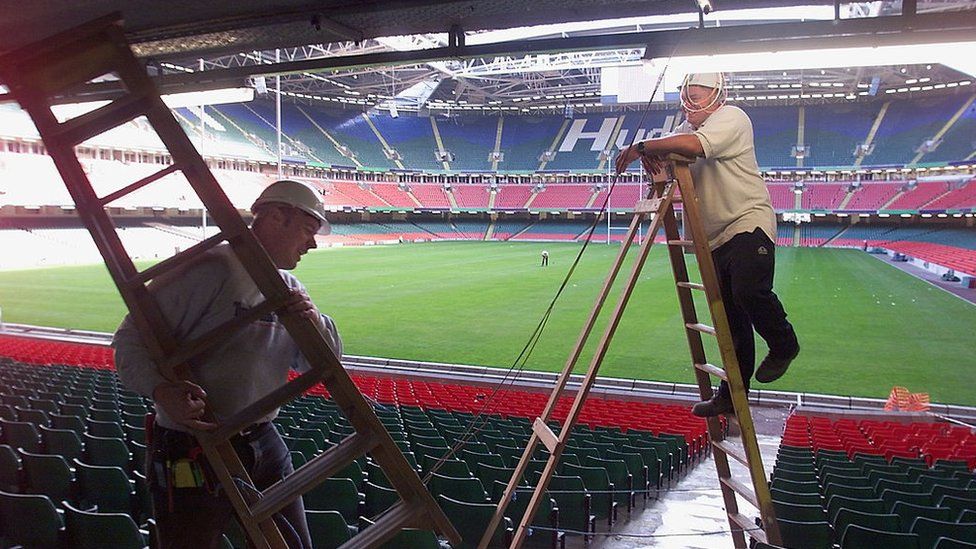 workmen in stadium