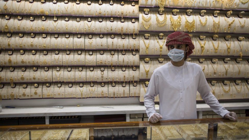 A seller wears a protective mask in a gold shop at Dubai Gold Market, Dubai