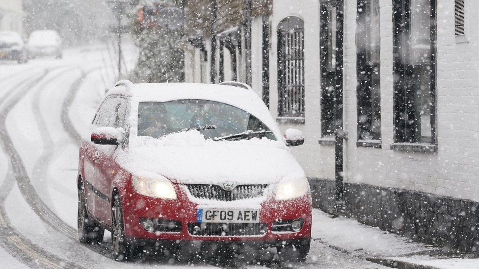 Car on a snowy road in Lenham, Kent