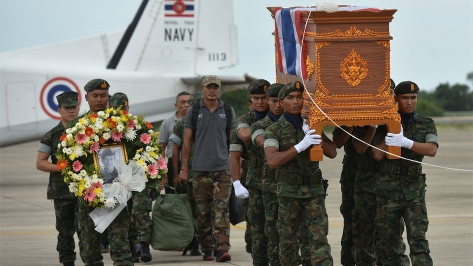 Saman Gunan's coffin is carried by soldiers