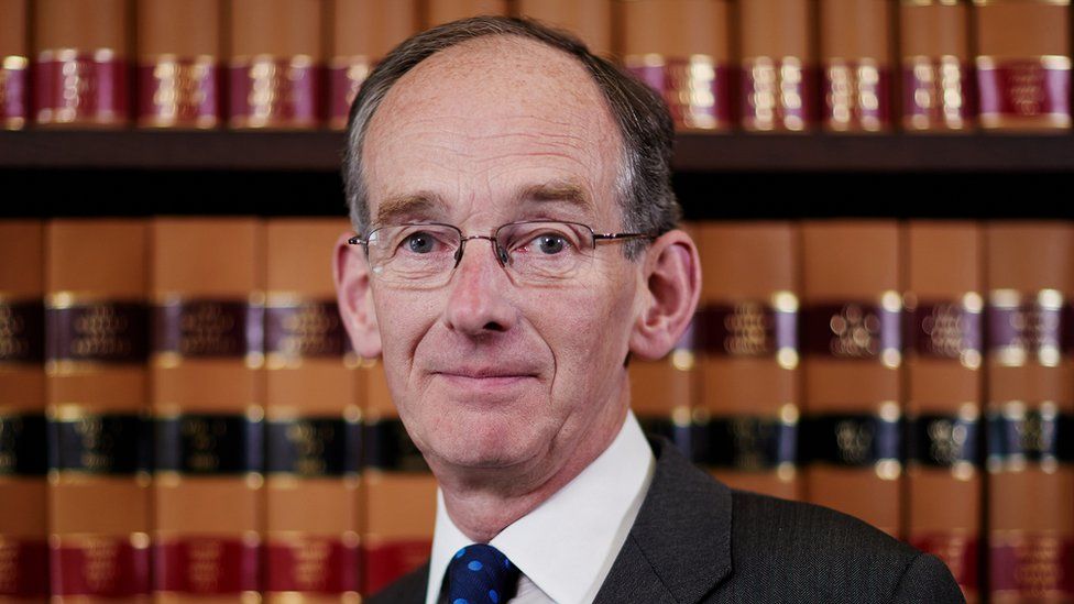 Sir Andrew McFarlane, President of the Family Court of England and Wales, pictured in front of a shelf of legal books