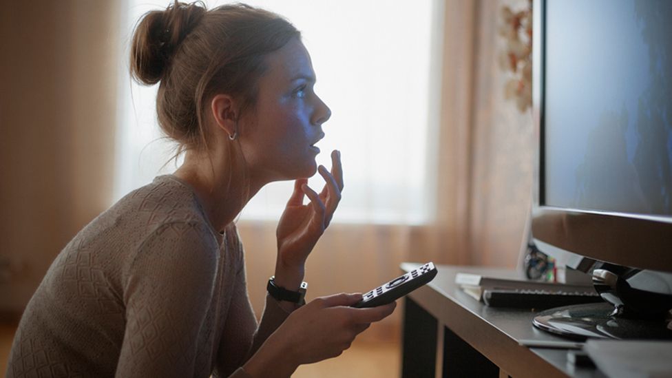 Stock image of a woman watching TV