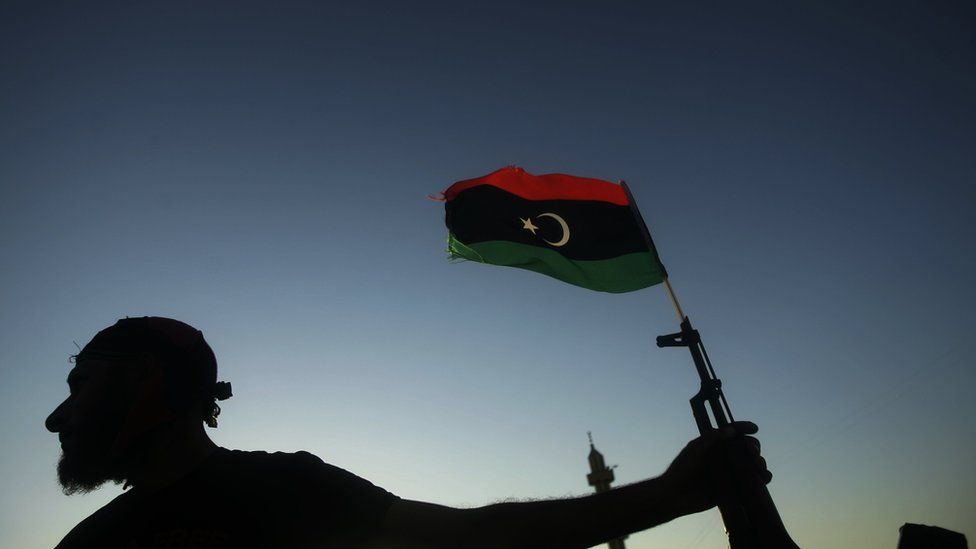 Libyan rebel with gun and flag