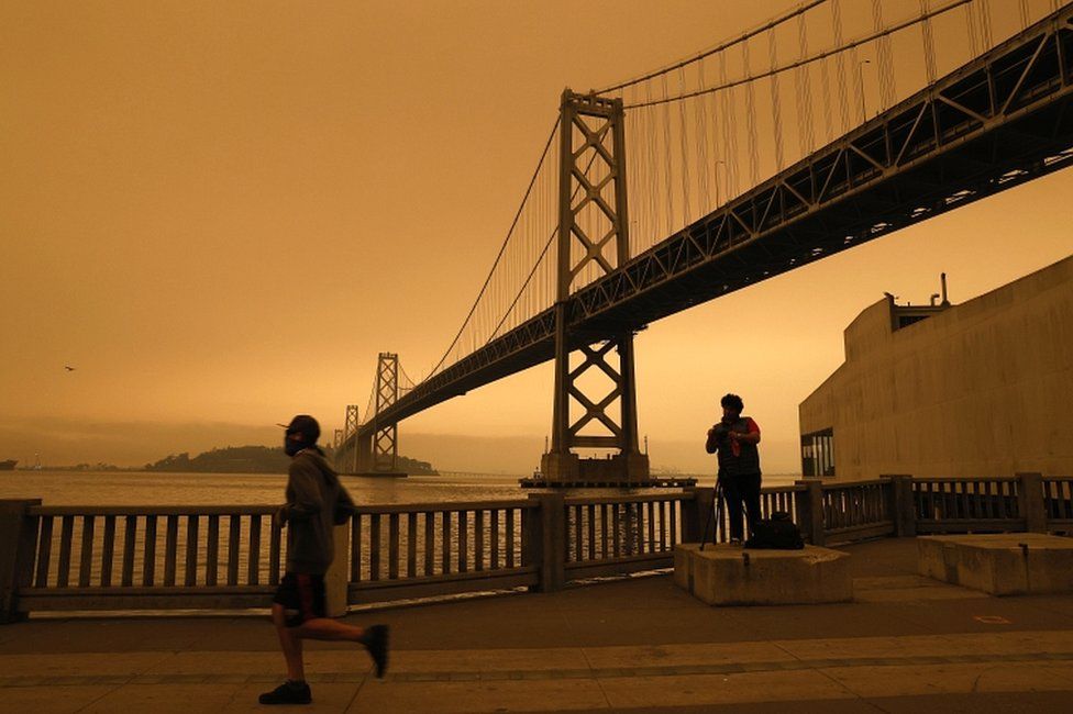 A view of the San Francisco Bay Bridge under an orange overcast sky in the afternoon in San Francisco, California, USA, on 9 September 2020