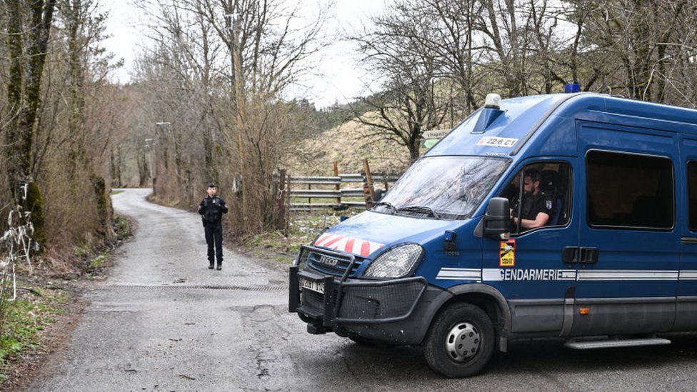 A French Gendarme stands on the road to the French southern Alps tiny village of Le Haut-Vernet,