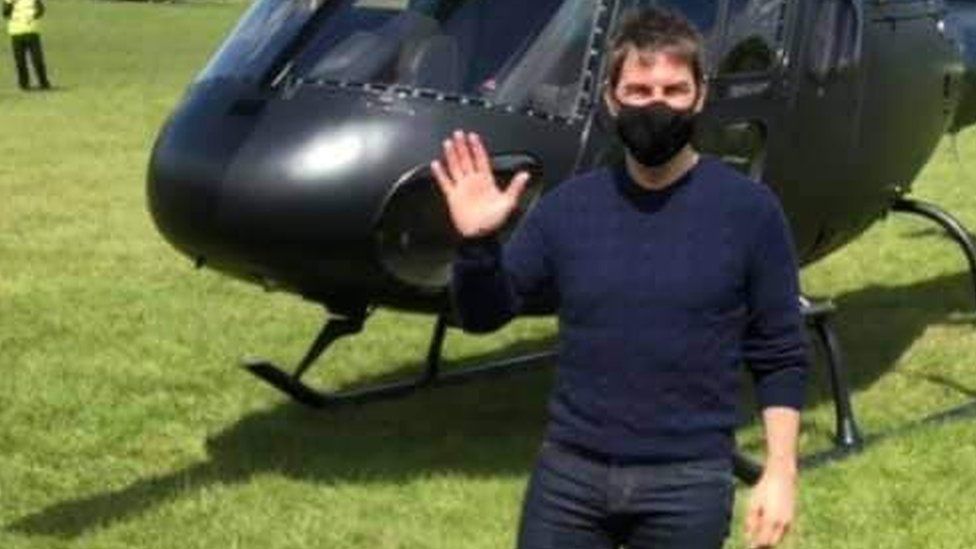 Covid: Tom Cruise signs shirts for football club on movie set - BBC News