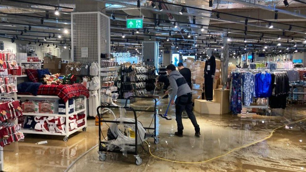 Shop workers cleaning up