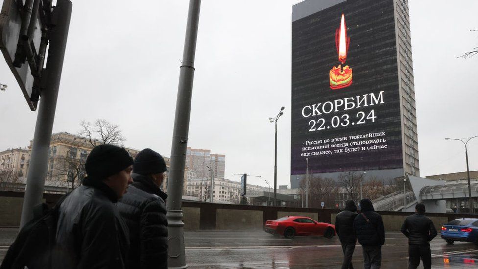 Screens all around Moscow are showing images of a burning candle along with the Russian word "Skorbim" ("We mourn").
