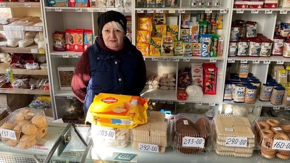 A Ukrainian supermarket worker talks to the BBC