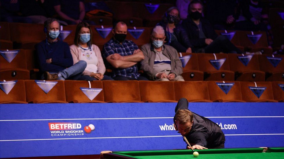Ali Carter is watched by spectators during his match against Jack Lisowski on day four of the Betfred World Snooker Championships 2021 at The Crucible, Sheffield.