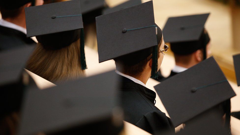 Students in graduate hats at a graduation.
