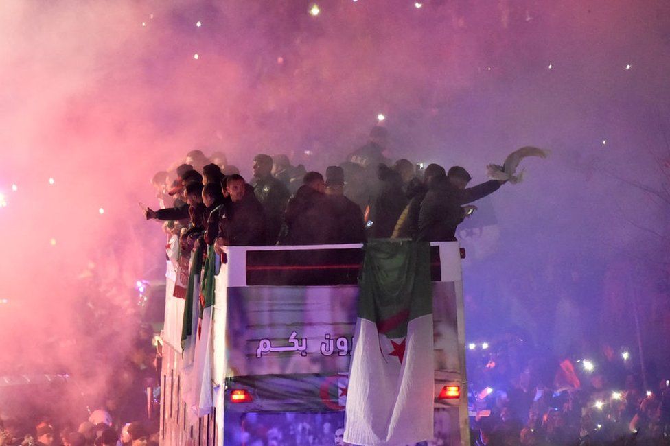 Algeria's national football team celebrates on a bus with their fans in Algiers, on December 19, 2021, a day after winning the FIFA Arab Cup 2021. - Africa Cup of Nations holders Algeria won the Arab Cup on December 18, beating Tunisia 2-0 after extra time in Qatar.