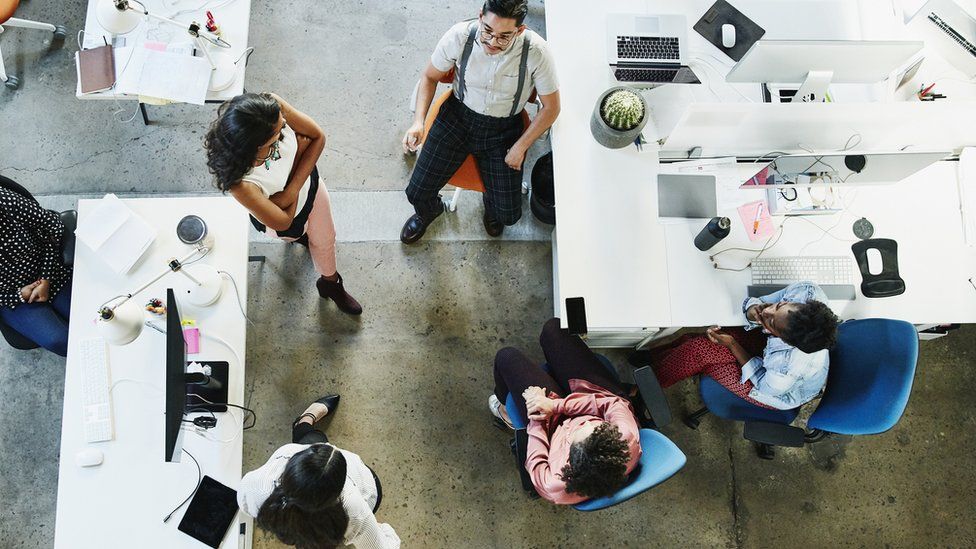 Overhead view of design team having project meeting in office - stock photo