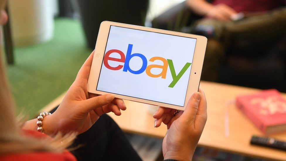 A woman using the eBay app
