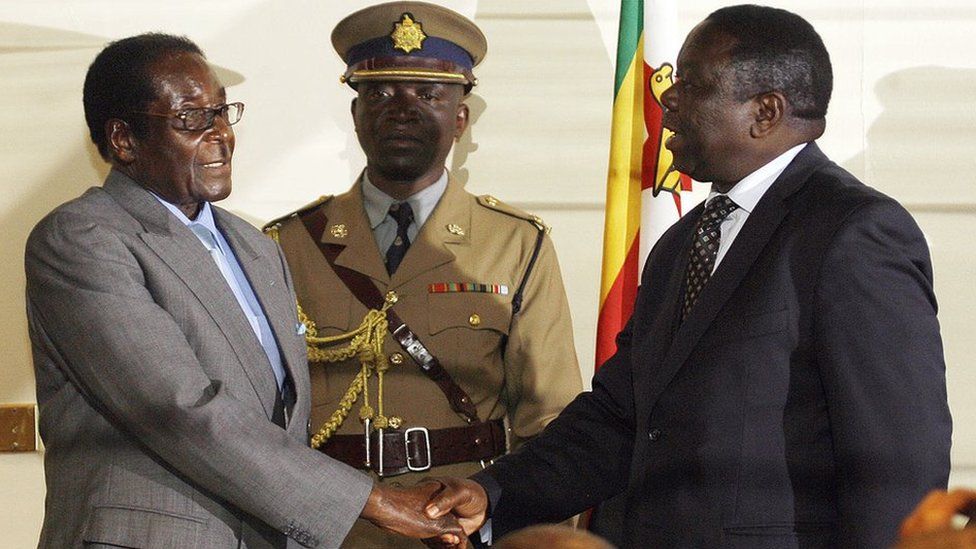Robert Mugabe and Morgan Tsvangirai shake hands