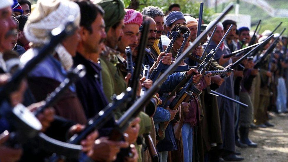 Men holding guns, standing in a line