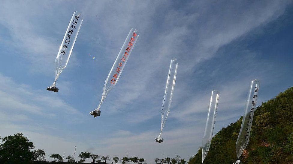 South Korean and US activists release balloons carrying anti-Pyongyang leaflets at a field near the Demilitarized zone