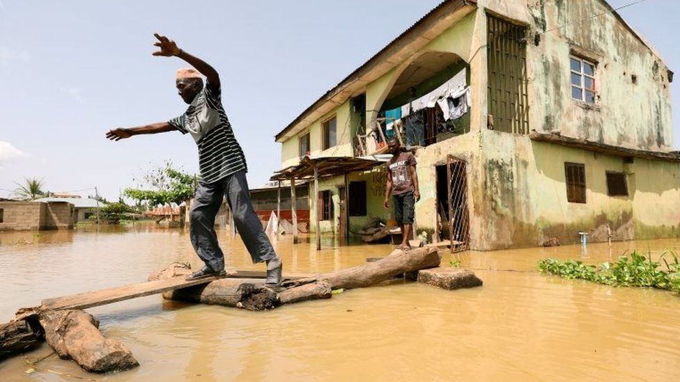 A man makes his way through flood waters in Kogi State, Nigeria September 17, 2018.