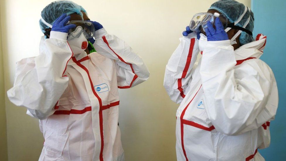 Kenyan health workers wear protective suits during a demonstration for preparations for any potential cases of the new coronavirus dubbed COVID-19, at the Mbgathi District hospital in Nairobi on March 6, 2020