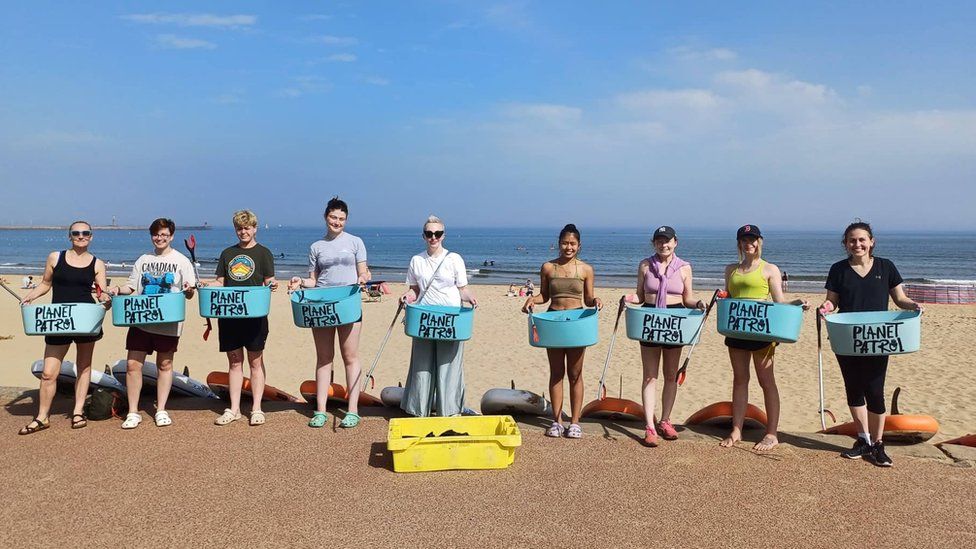 Volunteer litter pickers lined up along South Shields beach