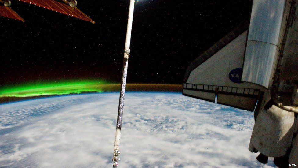 Atlantis docked with the ISS and the southern lights