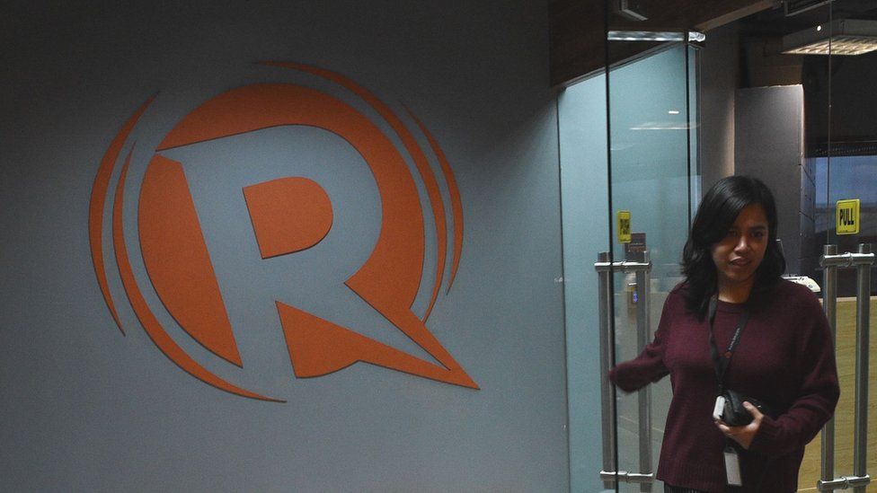 An employee leaves the editorial offices at news website Rappler in Manila, 15 January 2018