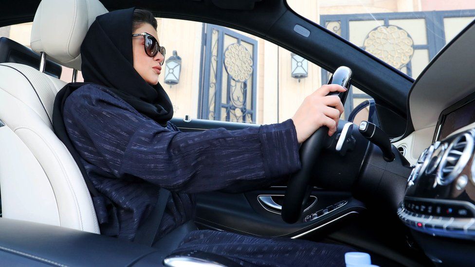 A Saudi woman sat in the driver's seat of a car