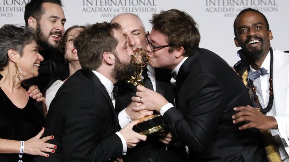 Writer Fabio Porchat (2-R) poses with the Especial de Natal Porta dos Fundo team in celebration of their best comedy award win during the 47th International Emmy Awards gala at the New York Hilton hotel
