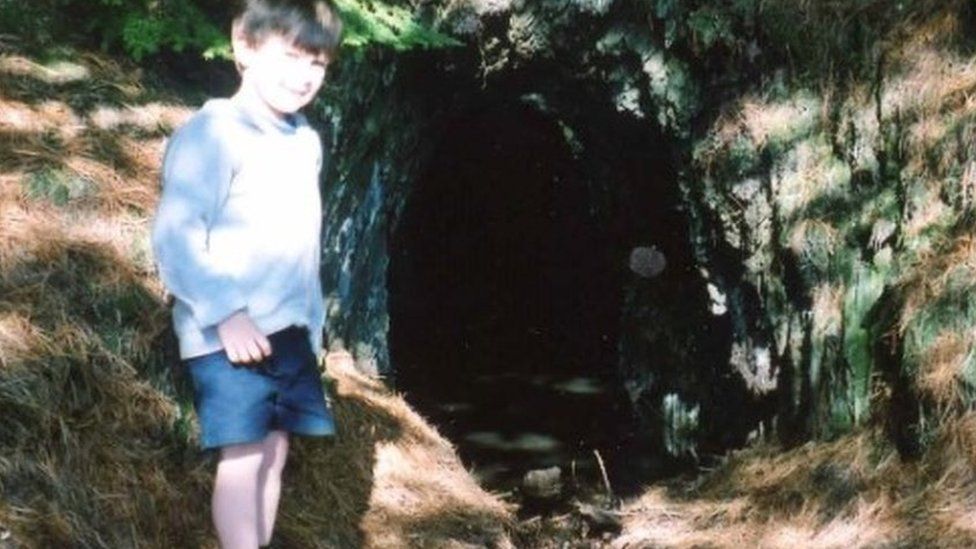 Ioan at a mine entrance as a child