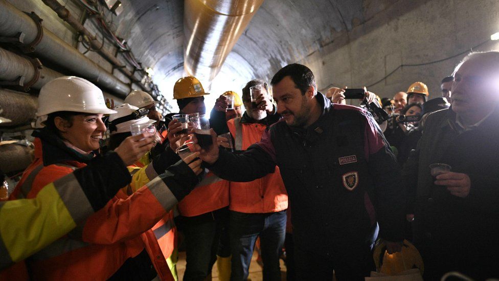Matteo Salvini drinks wine with workers during a visit to the building site of the TAV high-speed train line between Italy and France, on February 1, 2019 in Chiomonte, north-western Italy