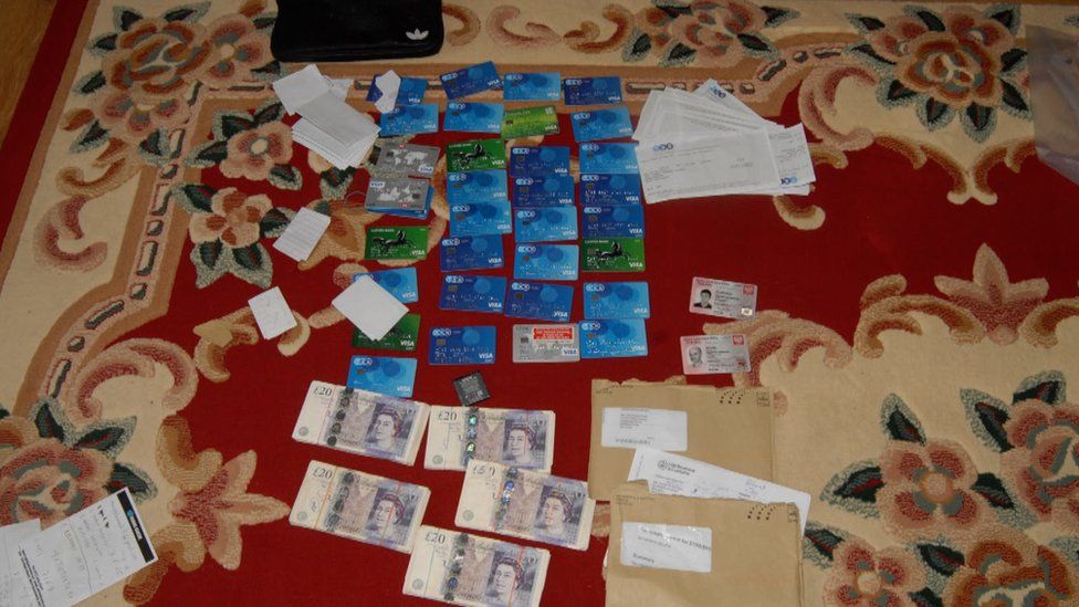 Cash and bank cards laid out on the floor