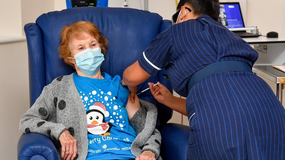 Margaret Keenan, 90, is the first patient in Britain to receive the Pfizer/BioNtech COVID-19 vaccine at University Hospital, administered by nurse May Parsons, at the start of the largest ever immunisation programme in the British history, in Coventry,