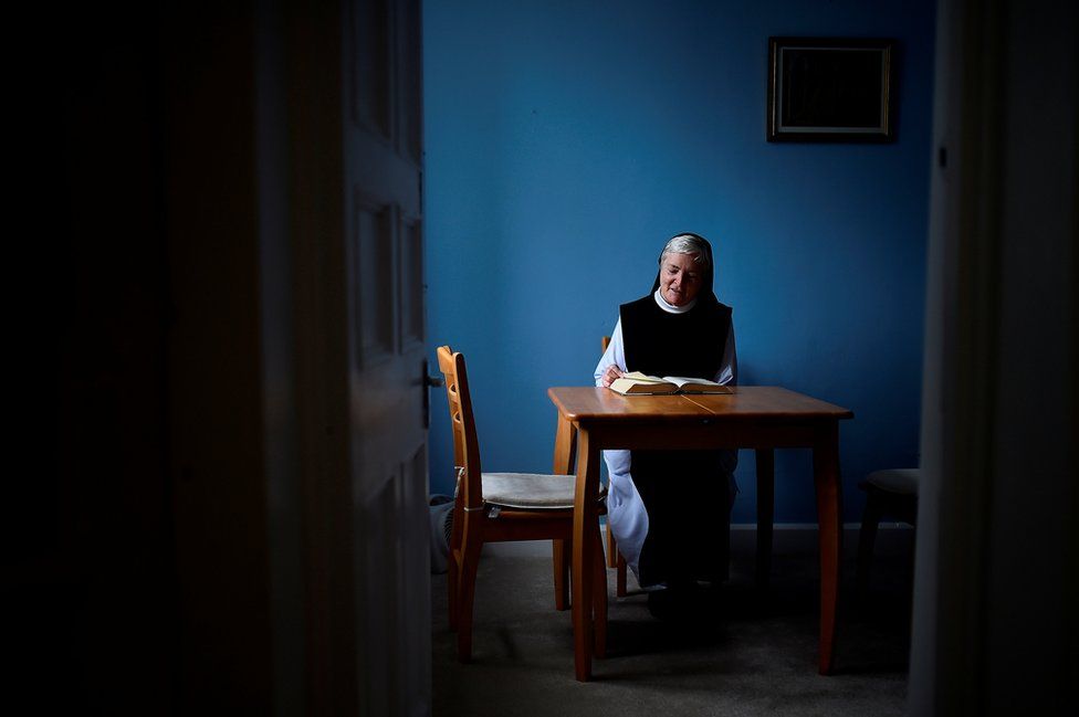 Sister Marie Fahy reads at her desk in St Mary's Abbey