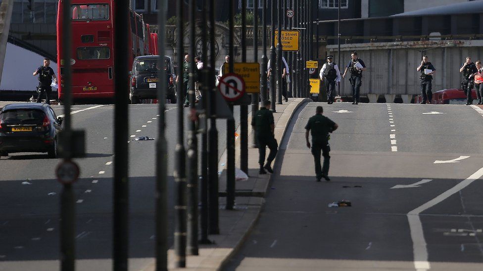 Members of the Police and Ambulance service assess the scene on London Bridge