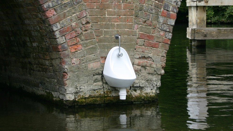 A urinal connected  the broadside  of Sonning Bridge.