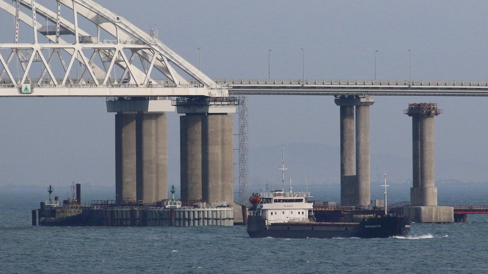 A vessel sails past a bridge connecting the Russian mainland with the Crimean Peninsula across the Kerch Strait, Crimea November 26, 2018