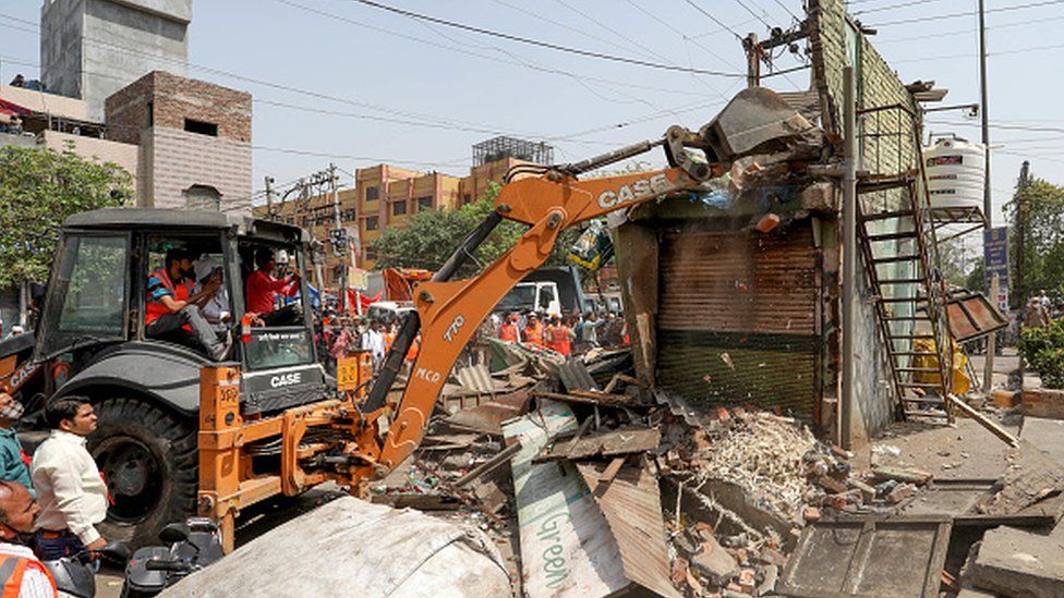 A bulldozer demolishes a structure during a joint anti-encroachment drive conducted by North Delhi Municipal Corporation at Jahangirpuri