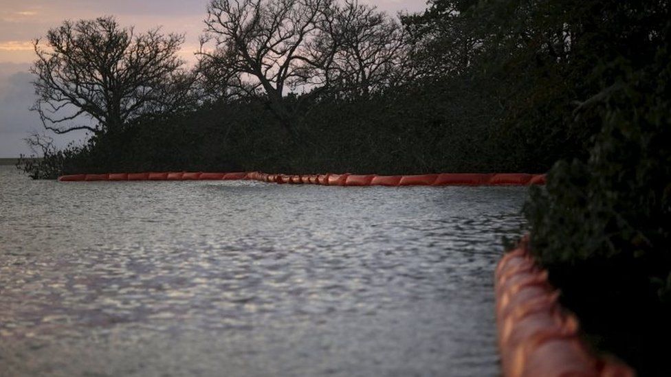 Oil barriers are placed on the mouth of Rio Doce to protect the vegetation of the mud after a dam, owned by Vale SA and BHP Billiton Ltd burst, in Regencia village November 20, 2015.